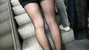 Sheer black pantyhose and short skirt.