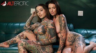 Two beautiful tattooed lesbians lick and play with their sex toys